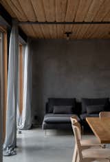 Living Room, Table, Sofa, Concrete Floor, Chair, and Ceiling Lighting  Photo 20 of 35 in Weekend House in Bukovany by SENAA architekti