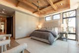Bedroom, Light Hardwood Floor, Table Lighting, Night Stands, Bed, and Chair Each of the bedrooms are generous size with loads of light.  The wood ceilings bring the northwest flair without being too rustic.  Photo 4 of 8 in The Nest on Lakeside by Carol Braun Measom