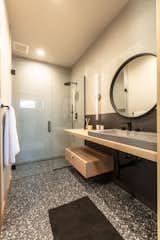Bath Room, Ceramic Tile Wall, Vessel Sink, Ceramic Tile Floor, Wall Lighting, One Piece Toilet, and Enclosed Shower Guest Ensuite Baths feature varied configurations of floating vanities and cool sinks.  Photo 6 of 8 in The Nest on Lakeside by Carol Braun Measom