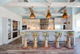 custom stools by sticks - pantry to left created w/vintage screened door, and found vintage side light windows flanking sides - lighting big ship salvage
