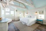 master bedroom - end table is vintage school desk, dressers vintage - exposed beams and stainless ductwork give place 'coastal industrial' feel --