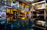 Elongated pool tiles in shimmering black and gold tile assists in cooling the house.