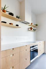 Kitchen, Cooktops, Vinyl Floor, Wall Oven, Range Hood, and Engineered Quartz Counter  Photo 15 of 26 in Harlan-Bogan House by Matthew Warner