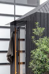 Exterior, Wood Siding Material, and Hipped RoofLine Highly textural traditional 'Yakisugi' burnt timber rainscreen. The char is 100% UV proof and repels water from the timber resulting in a very low maintenance cycle whilst providing a tactile aligator-like texture.  Photos from The Yakisugi Sauna
