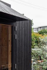 Exterior, Hipped RoofLine, and Wood Siding Material The sleek smooth aluminium brow contrasts with the intense texture of the Yakisugi.   Photo 4 of 7 in The Yakisugi Sauna