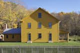 Exterior, Wood Siding Material, Metal Roof Material, and House Building Type Shades of ochre yellow are used on the exterior and interior of the home.  Photo 7 of 17 in The Best Scandinavian-Inspired Paint Colors for Your Home, According to Experts