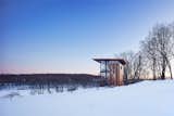 Designed by Minneapolis firm Sala Architects, the 820-square-foot Metal Lark Tower marked the first rental cabin to open at Nordlys Lodging, a 140-acre property in Frederic, Wisconsin. Small windows on the northwest side of the two-story structure provide privacy and protection from winter winds, while solar panels and natural heat insulated by the triple-paned windows add to the structure’s efficiency.&nbsp;