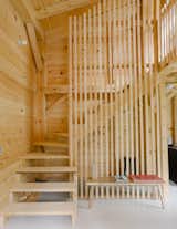 Vertical wood strips lend visual interest to Fern cabin’s staircase. "They are square wood pieces that create a screen and a closet area behind," David and Bill say.&nbsp;