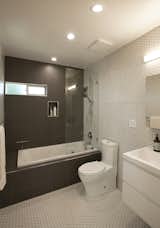 Bathroom Tiles by Antik in White. Size: 1 3/4” x 1 3/4” hex. Tiles by Demettra in 12 x 12. Color is SD44, Sculpture Gray.