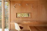 With the space swathed in rich plywood, two wall-mounted light sources stand out. "I am obsessed with them,