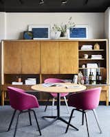Fuchsia felt chairs add a jolt of energizing color to the otherwise neutral workspace.