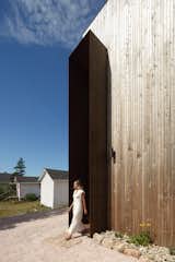 Double-height cedar cladding enhances the verticality of the structure.
