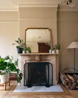 The clients embraced the home’s existing wood trim, and kept the stone fireplace as is—soot and all. “We use it so frequently, so we don’t clean it all the time,” they say. “At some point you just embrace it—we want the house to feel lived in.”