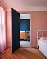 “We just wanted to embrace color,” the clients say about the top-floor guest room, painted Benjamin Moore’s Chippendale Rose. “We thought we’d make it fun; it’s a dusty, adult pink. We wanted to make it monochromatic, and we’re glad we did.”
