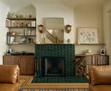 The cabinetry and the rebuilt fireplace—with an asymmetrical hearth and curved mantel—give the music room a retro vibe. “We spent so much time getting that right,"”says Jacoby. “The original fireplace had these curves; we wanted to echo them in the redesigned space.” The glossy green tiles surrounding the fireplace are double-glazed Heath Ceramics 2x4s in a luminous Jade hue.