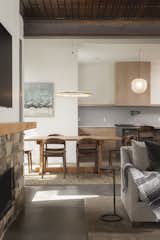 View of kitchen through the dining space. Mantle and dining table built with lumber from trees milled on site
