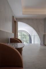 An opening in the shape of a quarter circle with a small cantilevering balcony has been added on the wall of the second level family space