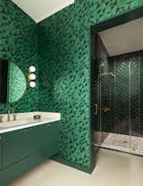 The guest bath features a celebration of emerald green.