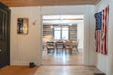 Entry with stained glass and original wood floors. A weathered American flag was found in the basement and hung on display. 
