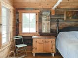 Bunkhouse decorated with vintage posters and painting found in the barn on the property. 