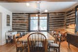 Dining room with updated lighting and restored wood chairs. A feeding trough from the barn was refurbished into a drink station.