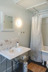 Marble sink and clawfoot tub refreshed with sea salt blue-green paint color throughout. 