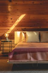 Southern light in upstairs bedroom with low vaulted ceilings. Floyd platform bed used for low clearance and modern look. 