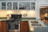 Cabinet doors were removed from most of the upper cabinets and painted white. For guests this makes it easier to see what is stocked when using an unfamiliar space. 