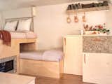 In this sleeping space for the couple, their teenage son, and two dogs, the designer used a natural, monochromatic palette with hues in the textiles shifting between cool and warm flesh tones to create harmony with the wood and grass finishes.