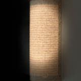 Wall sconces crafted by the designer from birch, LED lights, and Weitzner twill-weave raffia wallcoverings.