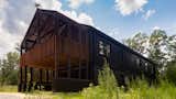 Exterior, Metal Siding Material, Gable RoofLine, House Building Type, Farmhouse Building Type, Stucco Siding Material, Wood Siding Material, and Metal Roof Material East Covered Terrace  Photo 8 of 12 in Nevils Creek Passive House by Kristina Held