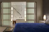 A glimpse of the master bath with a free-standing bathtub and a statuary marble accent