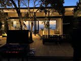 Outdoor, Back Yard, Landscape Lighting, Wood Patio, Porch, Deck, and Trees Waiting for the night you can enjoy de final sunset under the trees that already are beginning to light up  Photo 7 of 8 in Cerro la Higuera House by Rodrigo De la Cerda