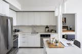 Polished kitchen with stainless steel GE appliances and island with bar seating 