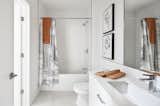 Spa-like bathroom with tub accentuated with eclectic prints 