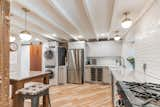 Kitchen, Drop In Sink, Refrigerator, Light Hardwood Floor, Range, Ceiling Lighting, Ceramic Tile Backsplashe, Pendant Lighting, Wood Cabinet, and Recessed Lighting Kitchen Entrance   Photo 2 of 29 in Guest House #2 by Monica Gagliardi