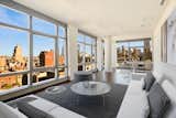 Unit 16A's living and dining area boast spectacular panoramic city views. 