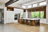 Kitchen, Light Hardwood Floor, and White Cabinet An open concept kitchen works equally well with intimate dinners and large family gatherings.  Photo 4 of 10 in Family Focused Modern by Horizon Pacific Contracting