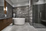 Use of stone in the ensuite bathroom reflects the home's West Coast setting.
