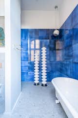 Bath Room, Ceramic Tile Wall, and Terrazzo Floor Bathroom with glazed lava stone tiles  Photo 10 of 10 in Apartment in former sanatorium by studio karhard