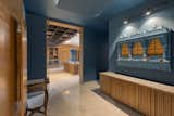 The main entrance of the house is scaled in height (has lower ceiling) to create a more intimate space when one enters. The dark single colour further adds to the dramatic effect of creating this space. 