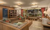 The central core of the house, where a majority of functions take place. The living space, reading nooks and dinning area all come together to create the central core of the house. Diffused light from the canvas ceiling fixtures, creates a warm environment, acquainted by other light features which orient themselves around the furniture. The use of warm colours along with wood and Kota stone table top creates subtle role in the whole setting.