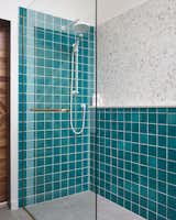 Curbless, integrated shower to maintain airiness in the 10x11 space with turquoise cracked tile by Fireclay Tile

Principal bathroom design renovation by INDA Interiors