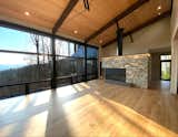 Living Room, Recessed Lighting, Light Hardwood Floor, and Gas Burning Fireplace Living Room with Modern Fireplace  Photo 3 of 7 in Elk Mountain Ridge by Vellum Architecture + Design