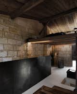 Living Room, Concrete Floor, Ceiling Lighting, Sofa, Wood Burning Fireplace, Wall Lighting, Floor Lighting, and Bench  Photo 9 of 11 in Sacré coeur, Stone House by Theo Domini