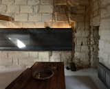 Dining Room, Bench, Table, Wall Lighting, Wood Burning Fireplace, and Concrete Floor  Photos from Sacré coeur, Stone House