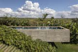 A concrete pool creates a connection from both volumes and provides the family a breathtaking view when they wish to take a swim. Photo: Leonardo Finotti