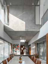 Dining Room, Chair, Ceiling Lighting, Table, and Limestone Floor double height dining space  Photo 11 of 14 in Gable House by UA Lab by UA Lab
