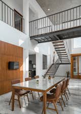 Dining Room, Chair, Table, Limestone Floor, and Ceiling Lighting double height dining space  Photo 8 of 14 in Gable House by UA Lab by UA Lab