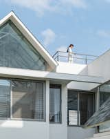 Exterior, Stone Siding Material, Shingles Roof Material, Metal Siding Material, Gable RoofLine, Concrete Siding Material, Brick Siding Material, Glass Siding Material, and House Building Type gable roof eve detail  Photo 5 of 14 in Gable House by UA Lab by UA Lab